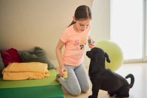 Therapiehund Paco mit Mädchen
